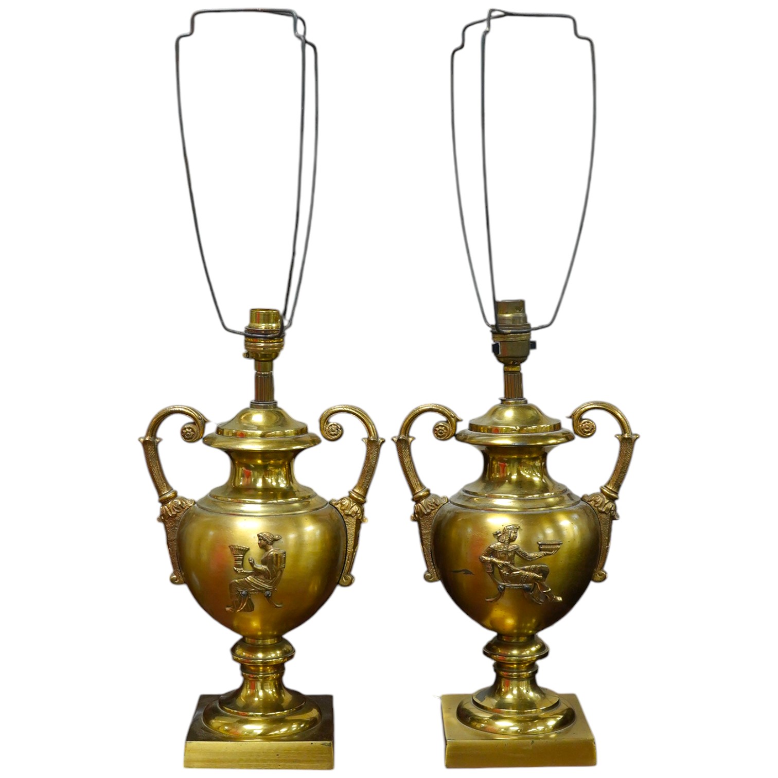 A pair of Empire style brass lamps with twin handles and applied decoration, 36cm high including the fitting. Condition - fair to good, untested